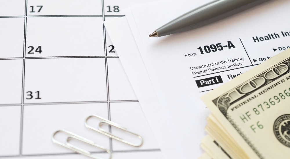 The printable IRS Form 1095-A with a pen is laying on the table